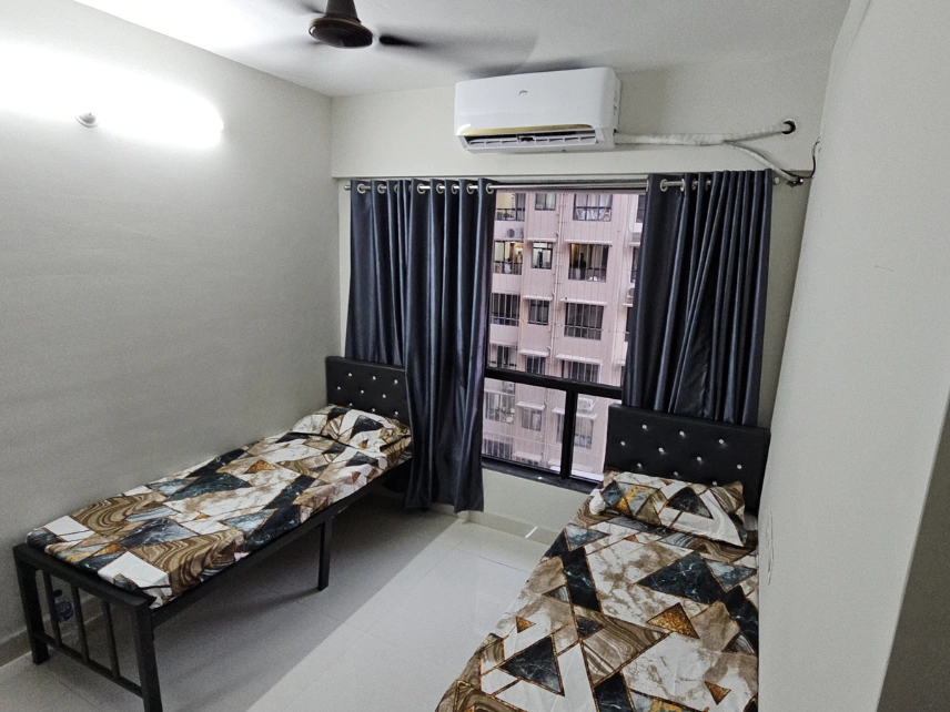 Shared room featuring modern furniture, organized storage, and spacious interiors in Dadar East