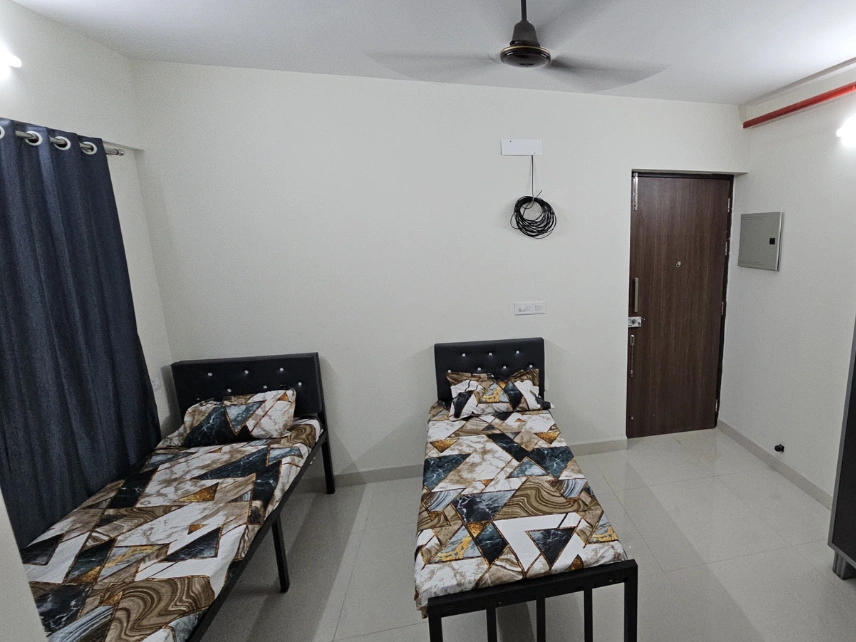 Modern shared room featuring organized furniture, bright interiors, and excellent ventilation