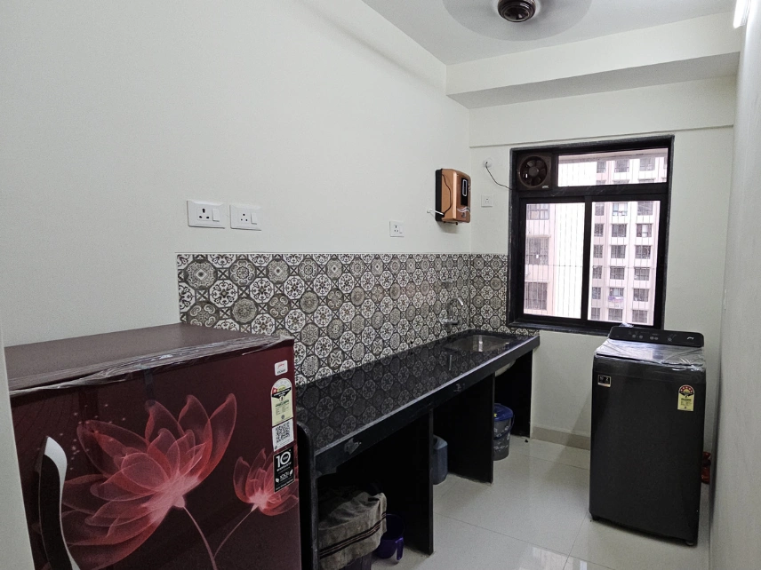 Shared kitchen with granite countertop, cooking stove, storage cabinets, sink, and meal preparation space