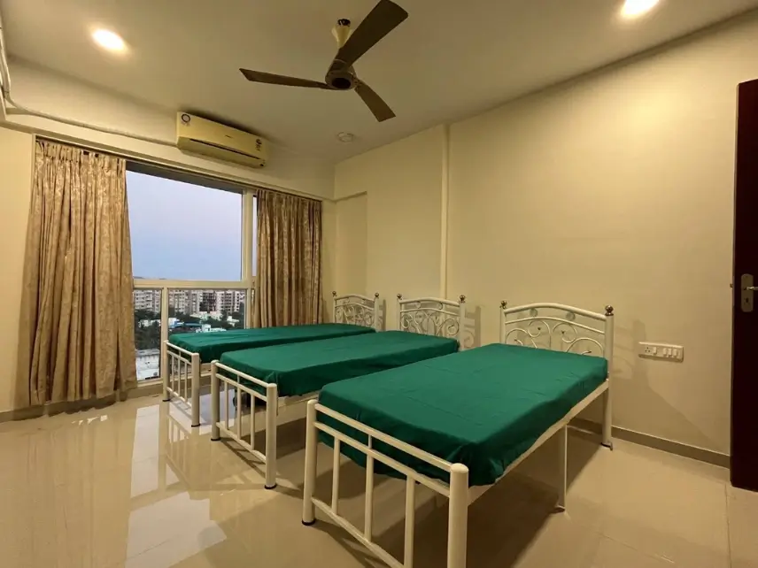 Triple sharing PG room with storage cabinets at Meridian Stays near JB Nagar Metro
