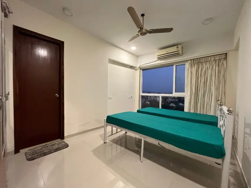 Fully furnished AC PG room with twin beds and storage space in JB Nagar Andheri East Mumbai