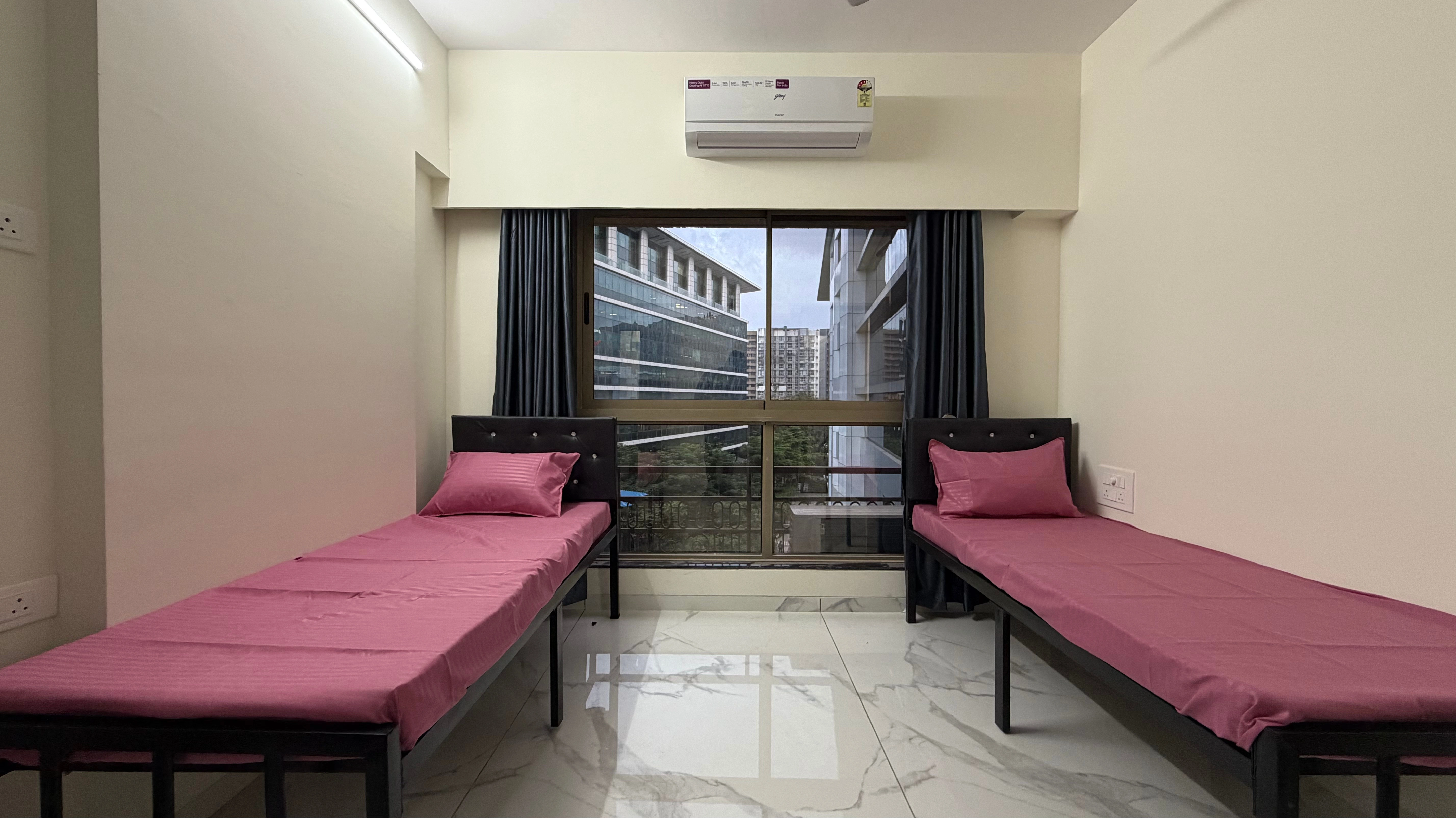 Two sharing PG room near BKC with comfortable beds and storage